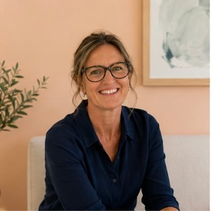 Bianca Hyslop, founder of WellfirstKIDS, smiling warmly in a dark blue blazer in her office