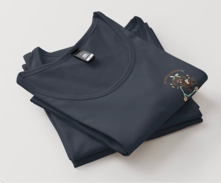 Folded dark navy sweatshirt with gold decorative emblem on sleeve displayed against white background